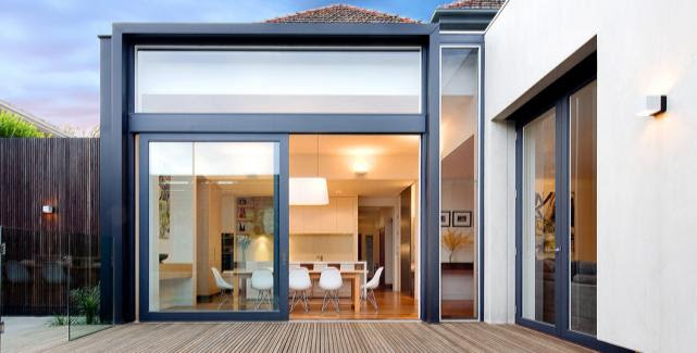 Folding patio doors opening to a lush garden, enhancing indoor-outdoor flow and natural light.