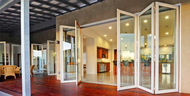 Elegant bi-fold doors opening to a patio in Orange County, enhancing indoor-outdoor living with natural light.