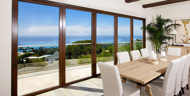 Open La Cantina folding patio doors blending indoor and outdoor spaces in an Orange County home.